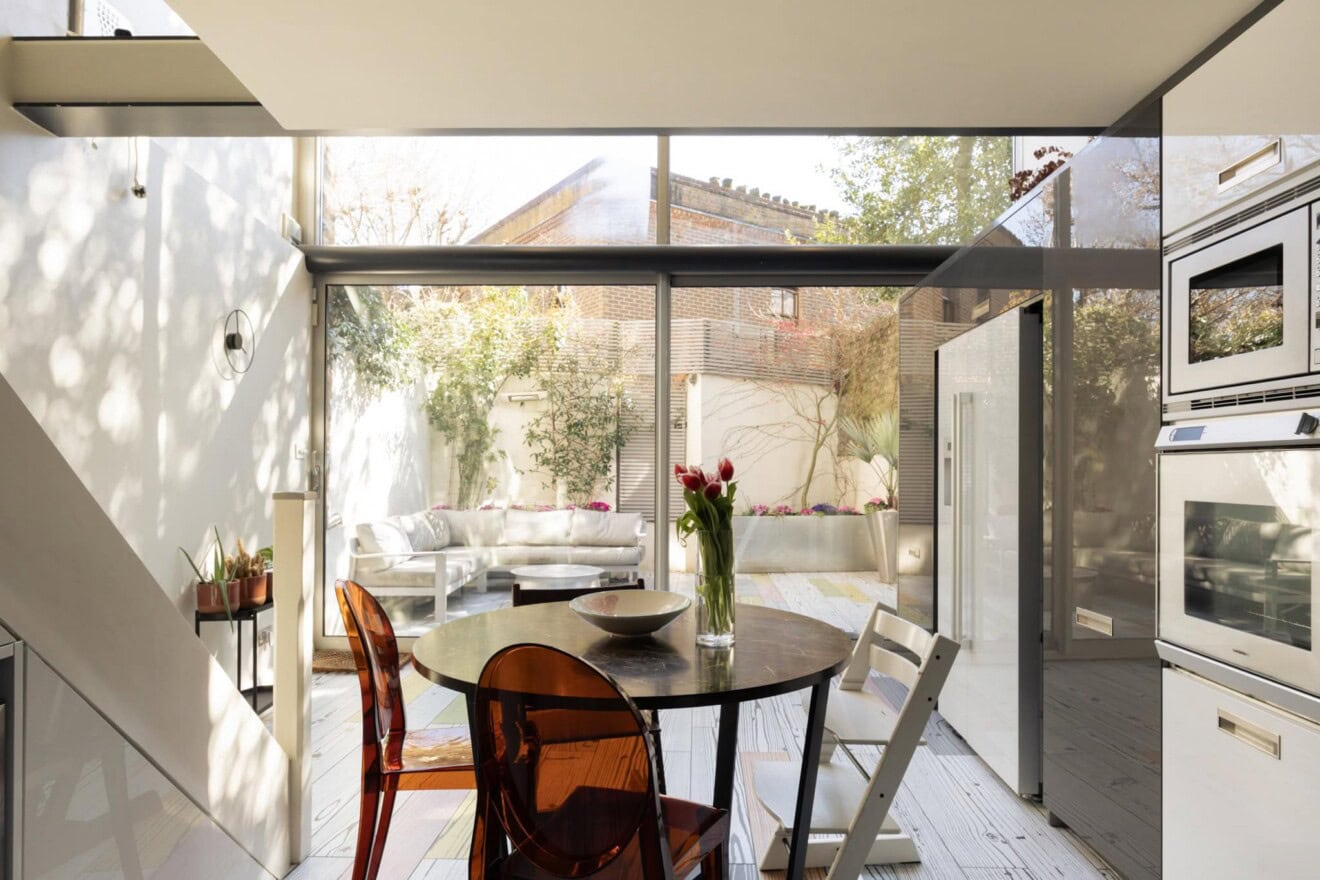 Bright, open-plan kitchen and dining space with floor-to-ceiling windows in Highgate, London.